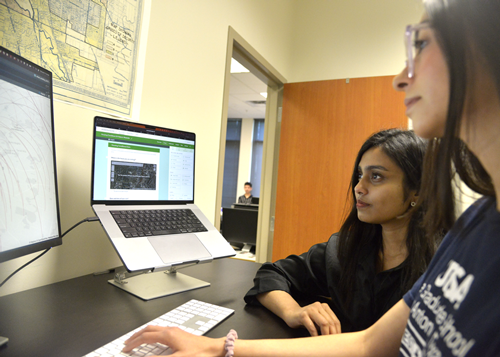 Group of UTSA urban and regional planning students working together.