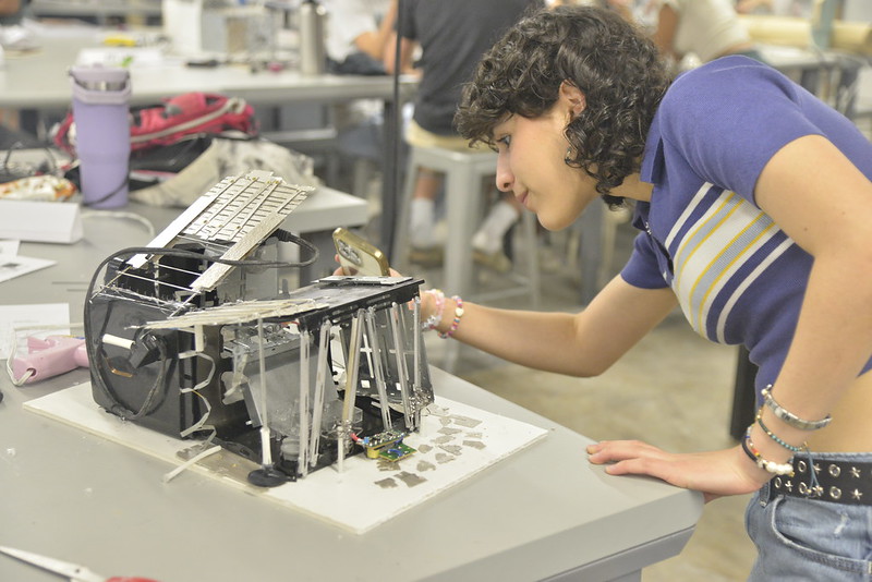 A summer camp participant working on their toaster house design