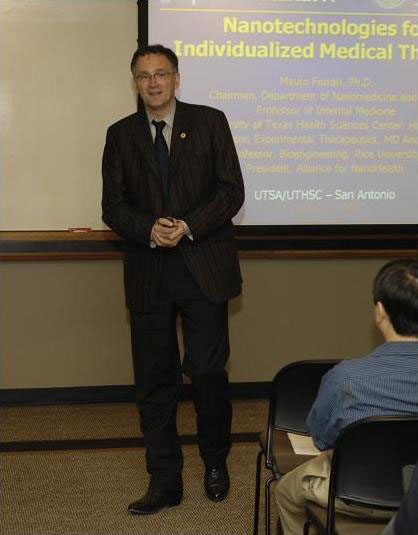 Mauro Ferrari in front of presentation slide