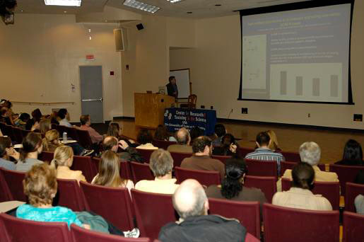 Bruce McEwen presenting in front of audience