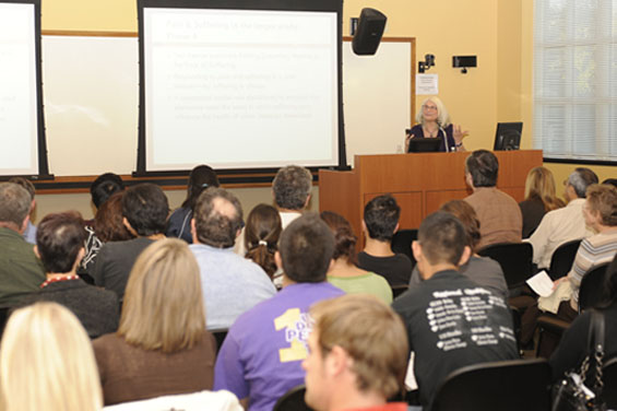 Elena Bastida presenting in front of audience