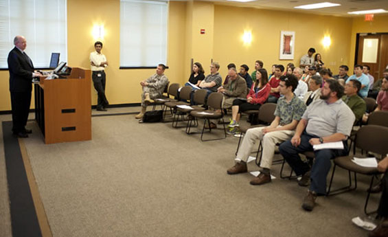 Larry McIntire presenting in front of audience