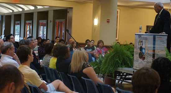 side view of Sidney McNairy, Jr. speaking in front of audience