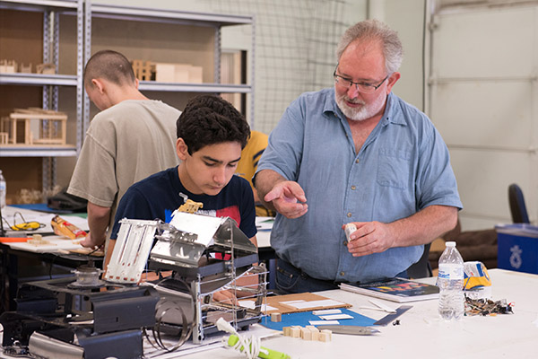 Architecture professor helping a student with a project during the architecture summer academy