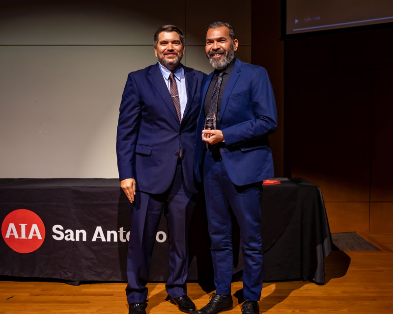 Armando Araiza, UTSA Architecture Department educator, celebrates receiving the 2024 AIA San Antonio Community Partner People Award with a colleague at the People + Place Celebration. This award honors Araiza's dedication to architectural education and community engagement.