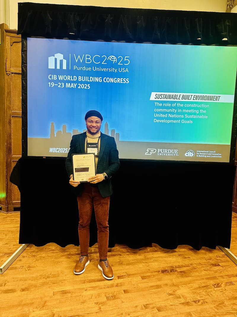 Roy Lan holding the award for best paper at the congress.