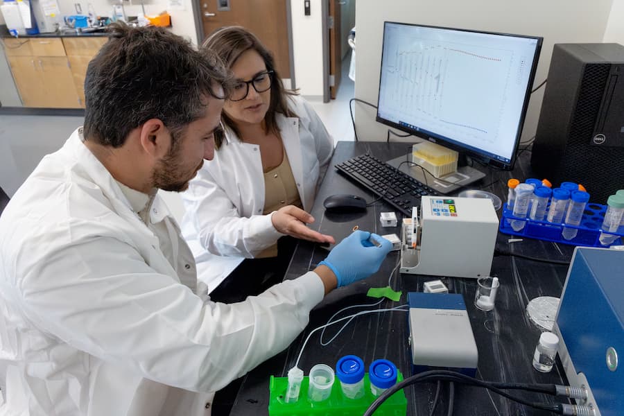 Southwest Research Institute and The University of Texas at San Antonio are funding the development of a smart biosensor coating to enable continuous monitoring and characterization of cells during the production of immunotherapies. Co-investigators Carlos M. Cantu, an SwRI research engineer, and Dr. Gabriela Romero Uribe, an associate professor in UT San Antonio’s Klesse College of Engineering and Integrated Design, plan to use smart sensors to automate processes to reduce human errors and costs associated with CAR T-cell production. Photo credit: Courtesy of SwRI