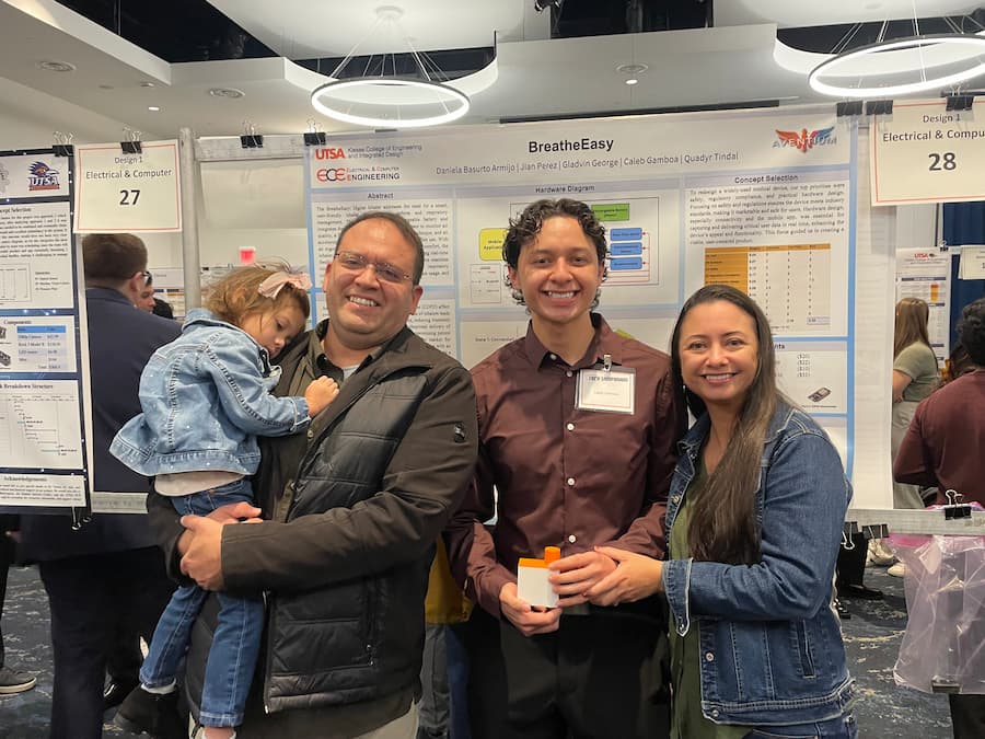 Caleb with his family, presenting his Tech Symposium project.
