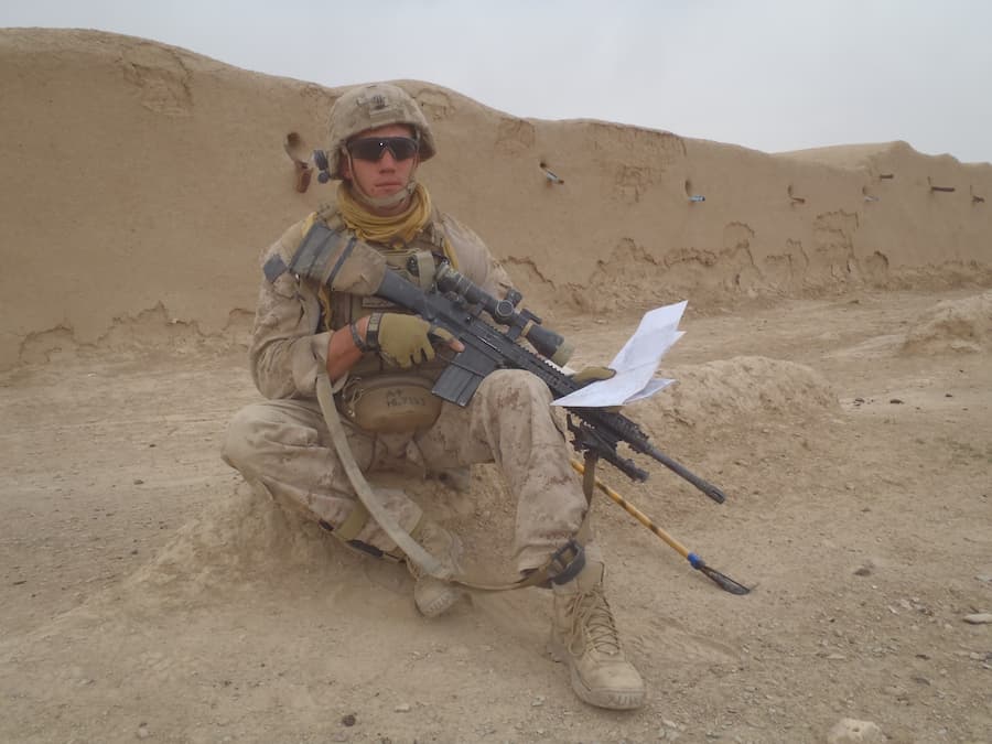 Jeremy wearing his military gear out in the field.