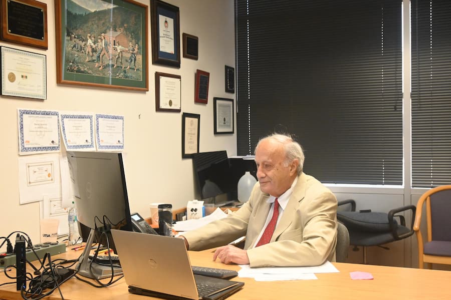 Karimi sitting at his desk.