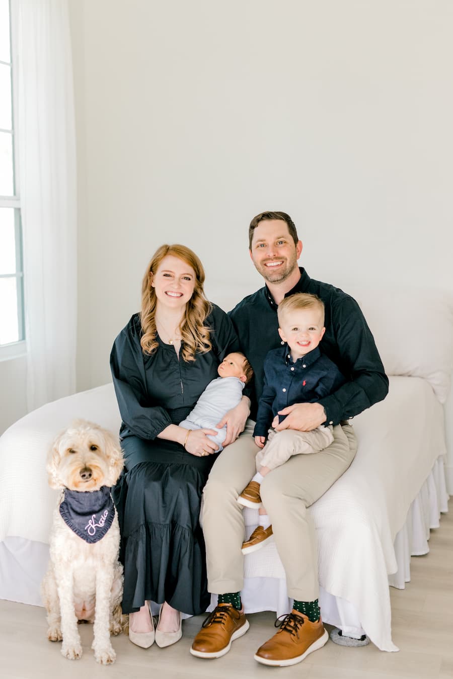 Kyle Bryson and Karina Bryson with their two sons, Levi and Logan, and their dog, Kaia.