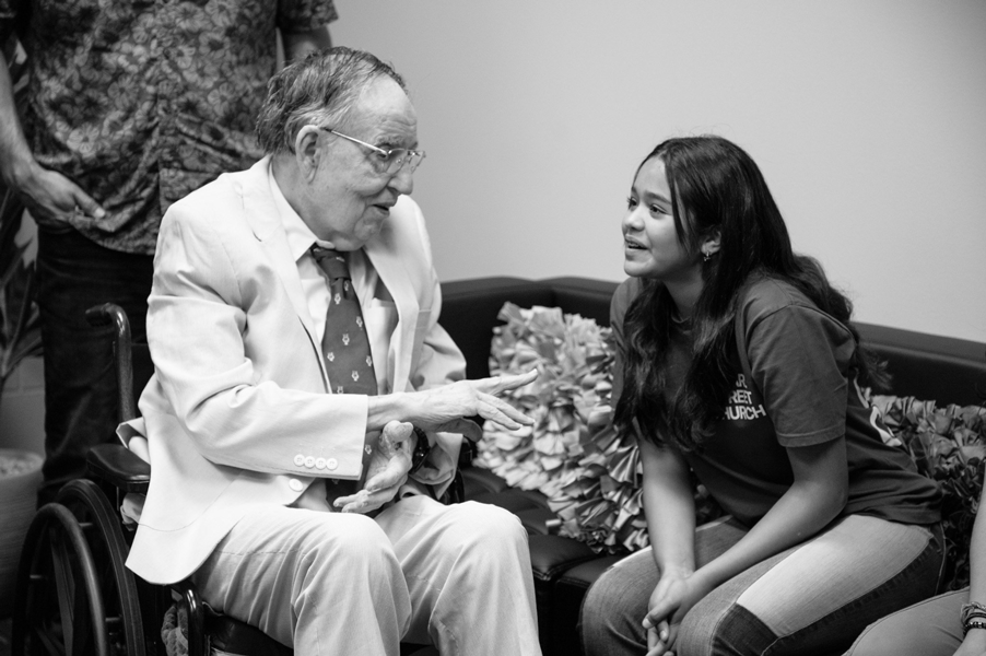 Manuel P. Berriozábal speaking with a student