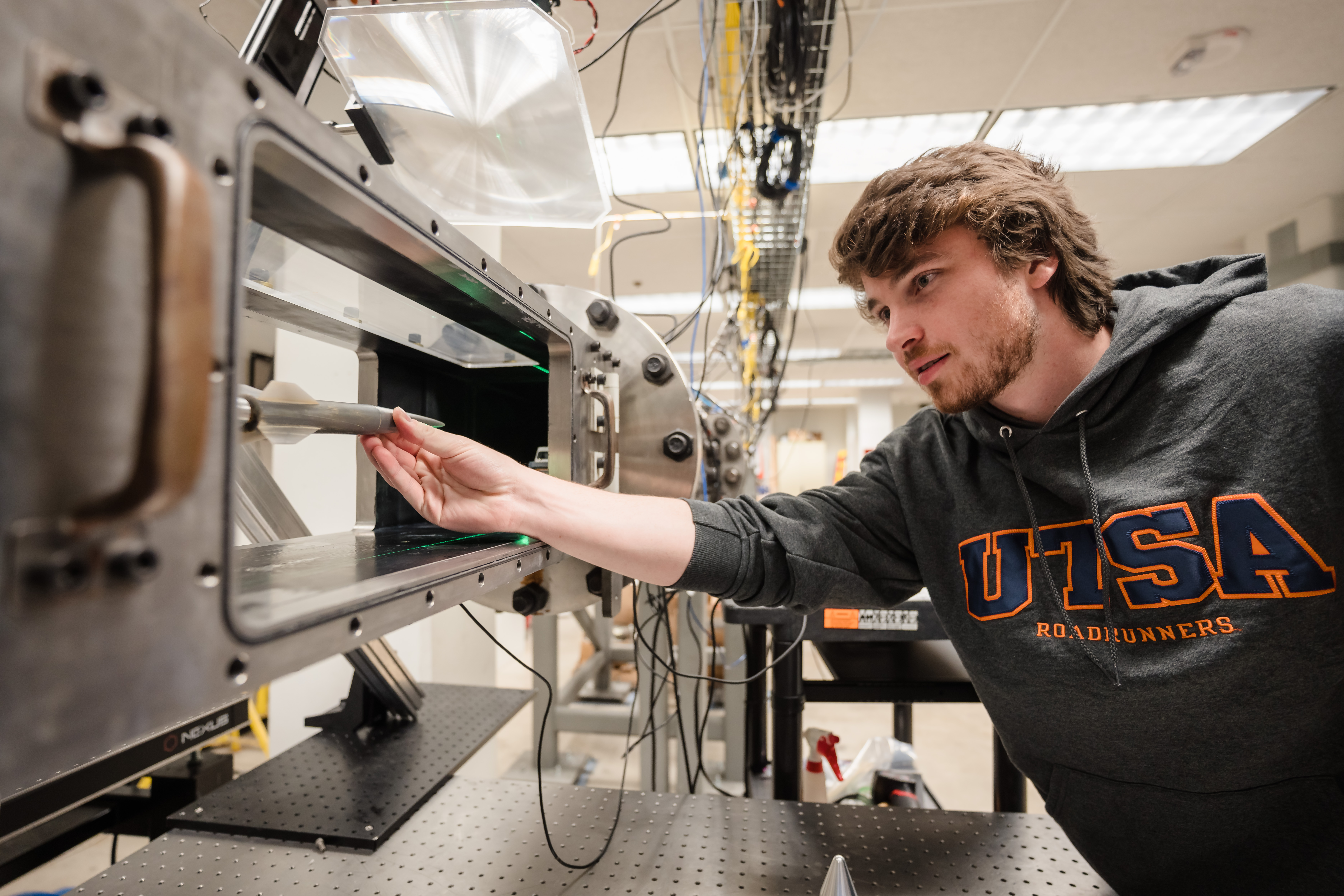 a student conducting engineering research with wind tunnel